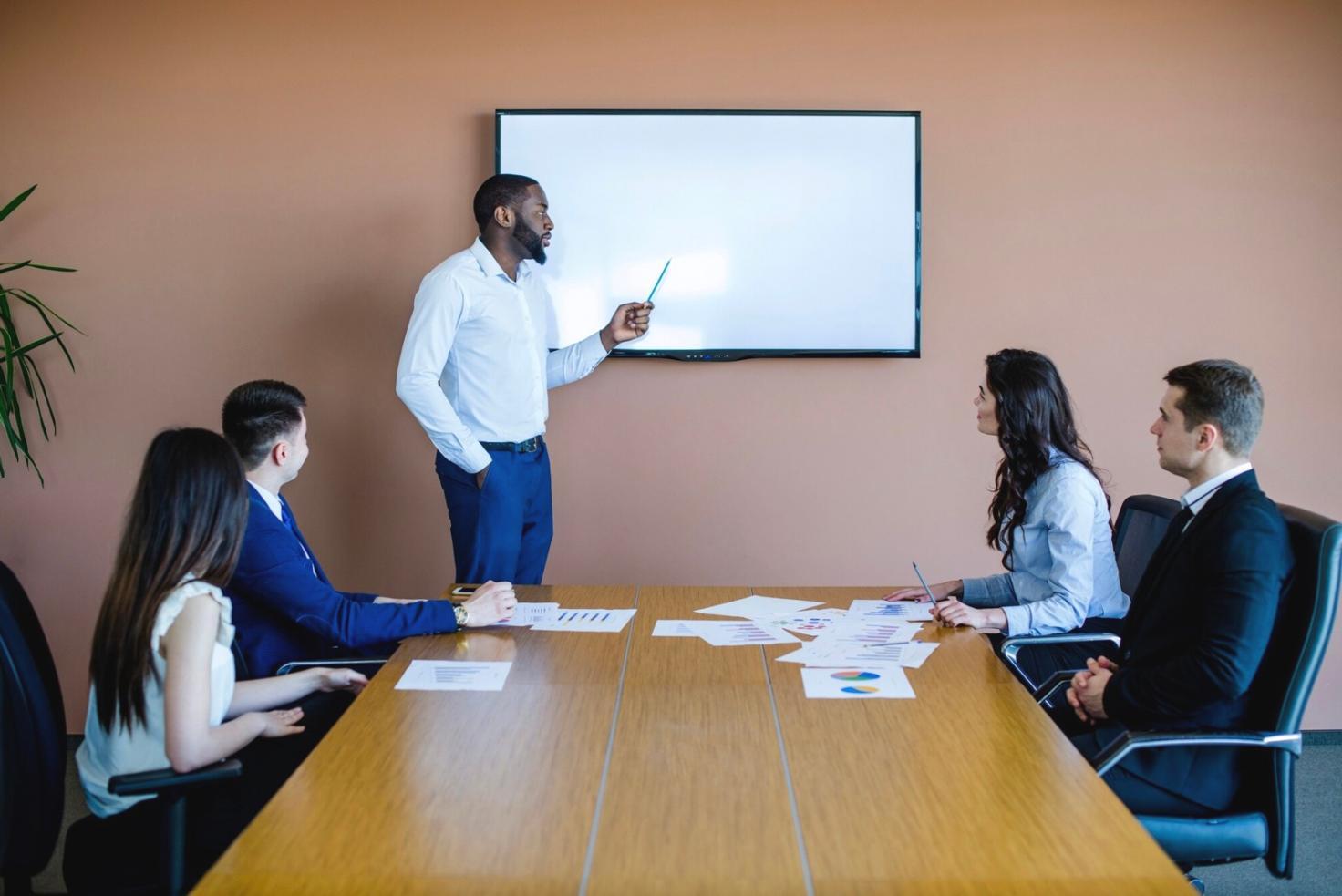 Professional reviewing financial reports on laptop